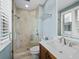 This bathroom features a glass shower, a sink, and a window at 340 Gulf Of Mexico Dr # 124, Longboat Key, FL 34228