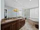 Spa-like bathroom with double vanity, soaking tub, and glass block accents at 340 Gulf Of Mexico Dr # 124, Longboat Key, FL 34228