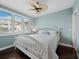 Bright bedroom features a white bed frame, a ceiling fan, and natural light from windows at 340 Gulf Of Mexico Dr # 124, Longboat Key, FL 34228