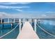 Picturesque dock extending over clear ocean waters, offering a serene waterfront view at 340 Gulf Of Mexico Dr # 124, Longboat Key, FL 34228