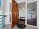Elegant entryway with a solid wood door, tiled floor, and glimpse of the interior at 340 Gulf Of Mexico Dr # 124, Longboat Key, FL 34228