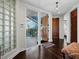 Grand foyer with hardwood floors, chandelier, and a view of the staircase at 340 Gulf Of Mexico Dr # 124, Longboat Key, FL 34228