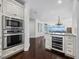 Modern kitchen with stainless steel microwave and oven, plus wine cooler for storing your favorite wines at 340 Gulf Of Mexico Dr # 124, Longboat Key, FL 34228