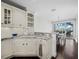 A classic kitchen featuring white cabinets, granite countertops, and a breakfast nook at 340 Gulf Of Mexico Dr # 124, Longboat Key, FL 34228