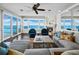 Bright living room features plush seating, a fireplace, and stunning waterfront views from expansive windows at 340 Gulf Of Mexico Dr # 124, Longboat Key, FL 34228