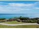 This stunning ocean view from the property showcases a walkway, greenery, and tranquil blue waters on a clear day at 340 Gulf Of Mexico Dr # 124, Longboat Key, FL 34228