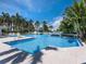 Resort-style pool featuring sun loungers and lush tropical landscaping at 340 Gulf Of Mexico Dr # 124, Longboat Key, FL 34228