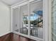 Large sliding glass doors offer an exquisite view of an outdoor dining area and stairs to the upper floor at 340 Gulf Of Mexico Dr # 124, Longboat Key, FL 34228