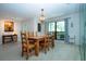 Bright dining room with wood table, chairs, overhead light, and art; natural light brightens the space at 3667 Country Place Blvd, Sarasota, FL 34233
