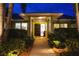 Inviting front entrance with lush landscaping and a well-lit path leading to the front door at 3667 Country Place Blvd, Sarasota, FL 34233