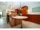 Stylish kitchen featuring a breakfast bar, pendant lighting, modern appliances, and warm cabinetry at 3667 Country Place Blvd, Sarasota, FL 34233