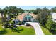 Beautiful home with terra cotta roof tiles, lush landscaping and scenic lake views at 3847 Little Country Rd, Parrish, FL 34219