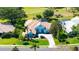 Aerial view of a home with tile roof, lush landscaping and expansive green lawn at 3847 Little Country Rd, Parrish, FL 34219