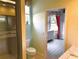 The bathroom is adjacent to another bedroom and features a glass-doored shower at 3847 Little Country Rd, Parrish, FL 34219
