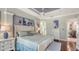 This spacious bedroom features a tray ceiling, a decorative bench, and a view into an ensuite bathroom at 3847 Little Country Rd, Parrish, FL 34219