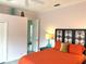 The bright bedroom features a black-framed headboard and ensuite access at 3847 Little Country Rd, Parrish, FL 34219