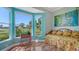 Bedroom with large windows, wood floors, daybed and view of backyard at 3847 Little Country Rd, Parrish, FL 34219