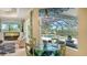 Dining area with decorative lighting, a glass table, and views of the screened-in pool area at 3847 Little Country Rd, Parrish, FL 34219