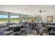 Bright dining area with scenic golf course views, elegant table settings and warm ambiance at 3847 Little Country Rd, Parrish, FL 34219