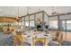 Inviting dining area with a cozy fireplace, elegant table settings, and a view of the bar and restaurant at 3847 Little Country Rd, Parrish, FL 34219