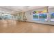Bright exercise room features a large mirror, natural light, and an adjacent outdoor pool for fitness and relaxation at 3847 Little Country Rd, Parrish, FL 34219