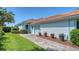 Charming home exterior with a tile roof, manicured landscaping, and a paved walkway leading to the entrance at 3847 Little Country Rd, Parrish, FL 34219