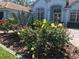 Charming home with colorful flowering bushes, mature plants, and decorative lamp post in the front yard at 3847 Little Country Rd, Parrish, FL 34219