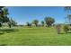 Scenic golf course view with lush green fairway, mature trees and a serene pond in the background, offering a tranquil setting at 3847 Little Country Rd, Parrish, FL 34219