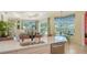 Bright kitchen with stainless steel appliances, marble countertops, an island, and views of the pool at 3847 Little Country Rd, Parrish, FL 34219
