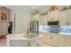 Well-equipped kitchen with white cabinets, a center island, and stainless steel appliances at 3847 Little Country Rd, Parrish, FL 34219