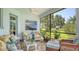 Charming lanai with comfortable seating, a ceiling fan, and scenic views of the landscaped backyard at 3847 Little Country Rd, Parrish, FL 34219