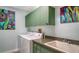 Convenient laundry room with modern appliances, ample counter space, and stylish green cabinetry at 3847 Little Country Rd, Parrish, FL 34219