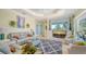 Cozy living room with tray ceilings, neutral colors, and access to the outdoor pool area at 3847 Little Country Rd, Parrish, FL 34219