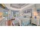 Main bedroom with hardwood floors, stylish furniture, tray ceilings, and pool views at 3847 Little Country Rd, Parrish, FL 34219