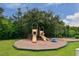 Delight in a charming community playground, featuring swings and slides surrounded by lush greenery and a picnic bench at 3847 Little Country Rd, Parrish, FL 34219