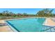Sparkling pool offers a refreshing escape with clear blue water, ample lounge seating, and serene surroundings at 3847 Little Country Rd, Parrish, FL 34219
