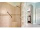Tiled walk-in shower featuring a built-in seat and glass block partition, providing privacy and light at 3847 Little Country Rd, Parrish, FL 34219