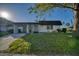 Charming single-story home with a lush green lawn and a convenient carport at 3904 Ashwood Ln, Sarasota, FL 34232