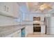 Contemporary kitchen boasts granite counters, stainless appliances, and ample cabinet space at 3904 Ashwood Ln, Sarasota, FL 34232