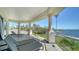 Spacious balcony with comfortable lounge seating and stunning views of the manicured lawn and waterfront at 404 S Shore Dr, Sarasota, FL 34234