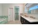 Stylish bathroom featuring double vanity, decorative green tiling, and a glass shower at 404 S Shore Dr, Sarasota, FL 34234