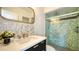 Modern bathroom featuring a vanity with a marble countertop and decorative tile backsplash at 404 S Shore Dr, Sarasota, FL 34234