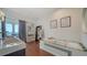 Bright bathroom with a modern tub, shelving, and framed art pieces providing a serene spa-like atmosphere at 404 S Shore Dr, Sarasota, FL 34234