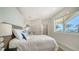 Comfortable bedroom with a large window offering scenic outdoor views and lots of natural light at 404 S Shore Dr, Sarasota, FL 34234