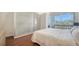 Bright bedroom with white walls, hardwood floors, and a sliding glass door for natural light and balcony access at 404 S Shore Dr, Sarasota, FL 34234