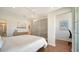 Inviting bedroom features a cozy bed, hardwood floors, and a sliding glass door leading to a bright office space at 404 S Shore Dr, Sarasota, FL 34234