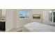 Bright bedroom featuring a wall-mounted TV, tiled floors, and a private ensuite at 404 S Shore Dr, Sarasota, FL 34234