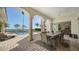 Covered outdoor dining area with seating for six, overlooking the pool and waterfront at 404 S Shore Dr, Sarasota, FL 34234