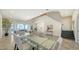 Spacious dining area featuring a modern glass table, neutral decor, and scenic waterfront views at 404 S Shore Dr, Sarasota, FL 34234