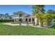 Beautiful home with a sparkling pool, lush landscaping, and elegant design showcasing a luxurious outdoor space at 404 S Shore Dr, Sarasota, FL 34234